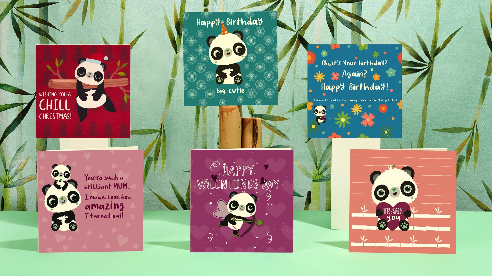Lifestyle photography of Panda Joy Eco-Friendly, recyclable, biodegradable, tree free bamboo and cotton linter greeting card range with green bamboo and green background.