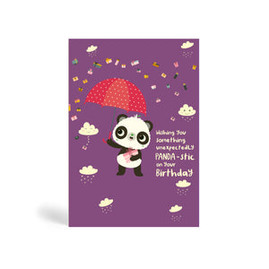 A6 purple eco-friendly, tree free, birthday greeting card with Panda standing, holding a present and umbrella. In the background, there is images of clouds and raining presents. The card say, Wishing You Something Unexpectedly Panda-stic on your Birthday!