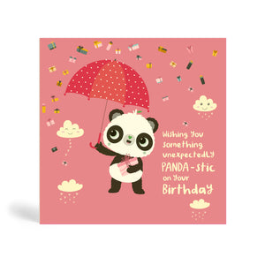 150mm square pink eco-friendly, tree free, birthday greeting card with Panda standing, holding a present and umbrella. In the background, there is images of clouds and raining presents. The card say, Wishing You Something Unexpectedly Panda-stic on your Birthday!