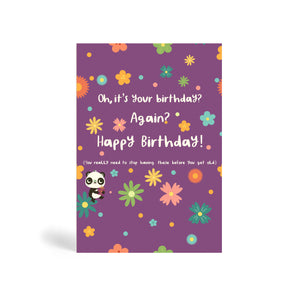 Purple A6 eco-friendly, tree free, birthday greeting card with several colourful flowers and Panda sitting on a green flower holding a present. The card says, Oh, it’s your birthday? Again?  Happy Birthday! You really need to stop having these before you get old.