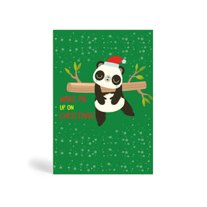 Green A6 Eco-Friendly Christmas greeting card with Christmas tree background design made from bamboo and cotton linters with image of Panda sleeping hanging from a tree. The card says Chilling Until Christmas!