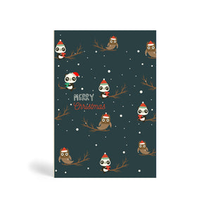 Navy blue A6 Eco-Friendly Christmas greeting card, recyclable, biodegradable, green, tree-free made from bamboo and cotton linter with snow in the background and image of three Panda and two Owl wearing Santa hat and sitting on trees. The Pandas are holding a green or red Christmas present. The card says, MERRY CHRISTMAS.