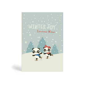 Light blue A6 Eco-Friendly, recyclable, biodegradable, green, tree-free Winter joy, Christmas Wishes - Skating on Lake greeting card, with snowflakes and mountains in the background. 